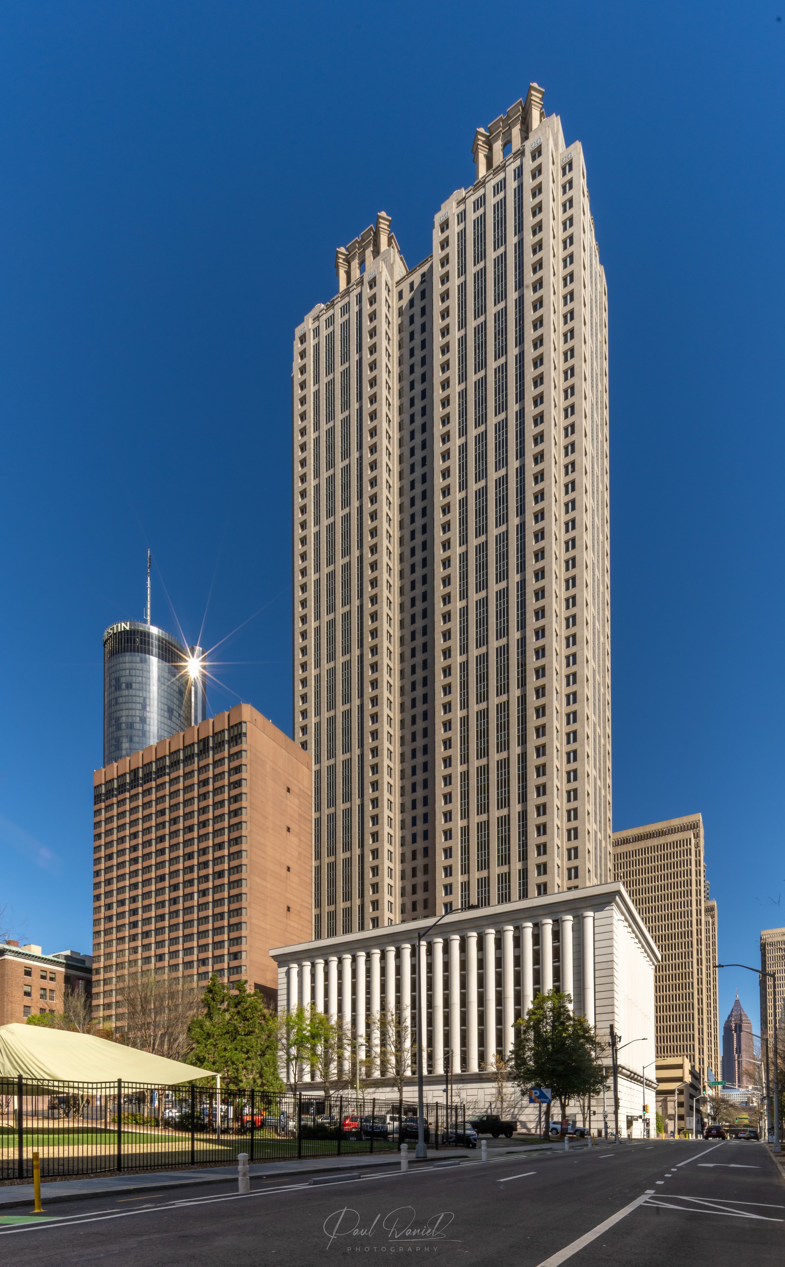 Full vertical architectural view of 191 Peachtree Tower under a clear blue sky in Downtown Atlanta, GA