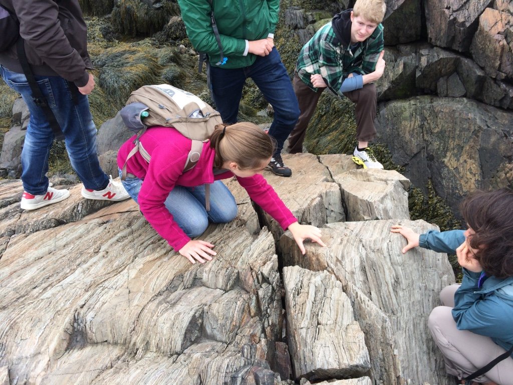 Group of researchers on some rocks outside