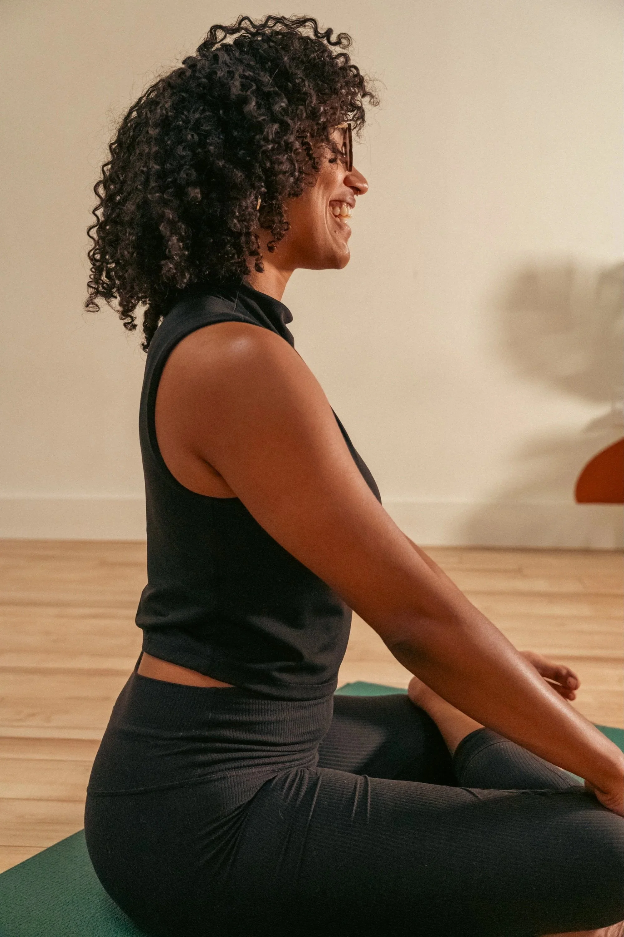 Victoria Rutledge, yoga instructor and grief coach, in a happy, meditative pose.