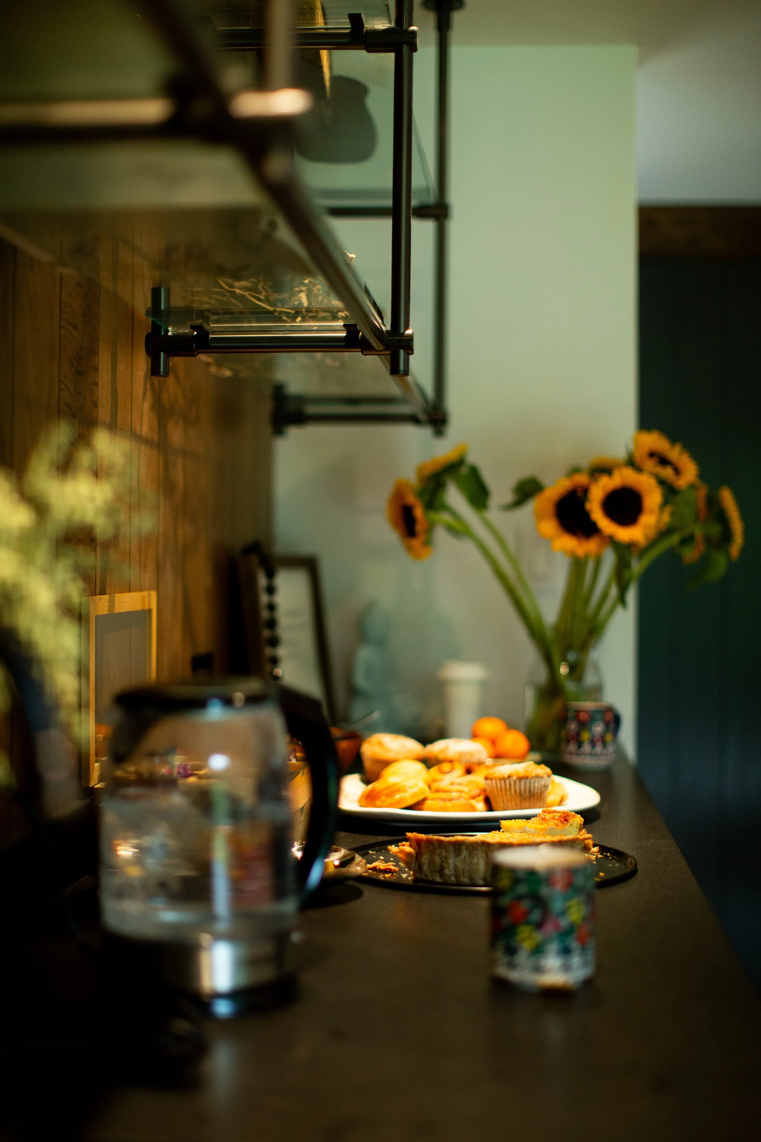 A spread of food with tea, scones and flowers