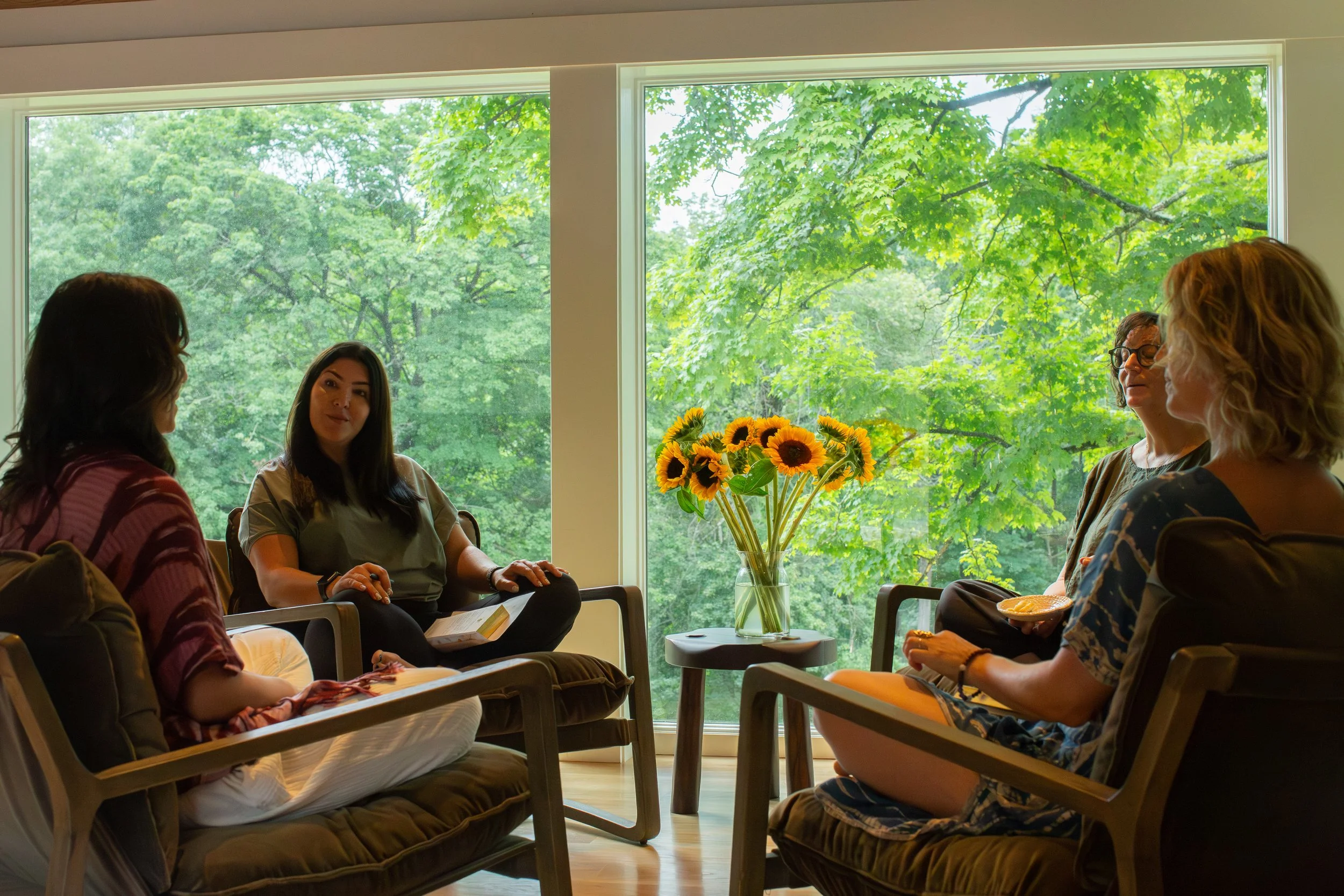 Four women gathering in a cozy setting