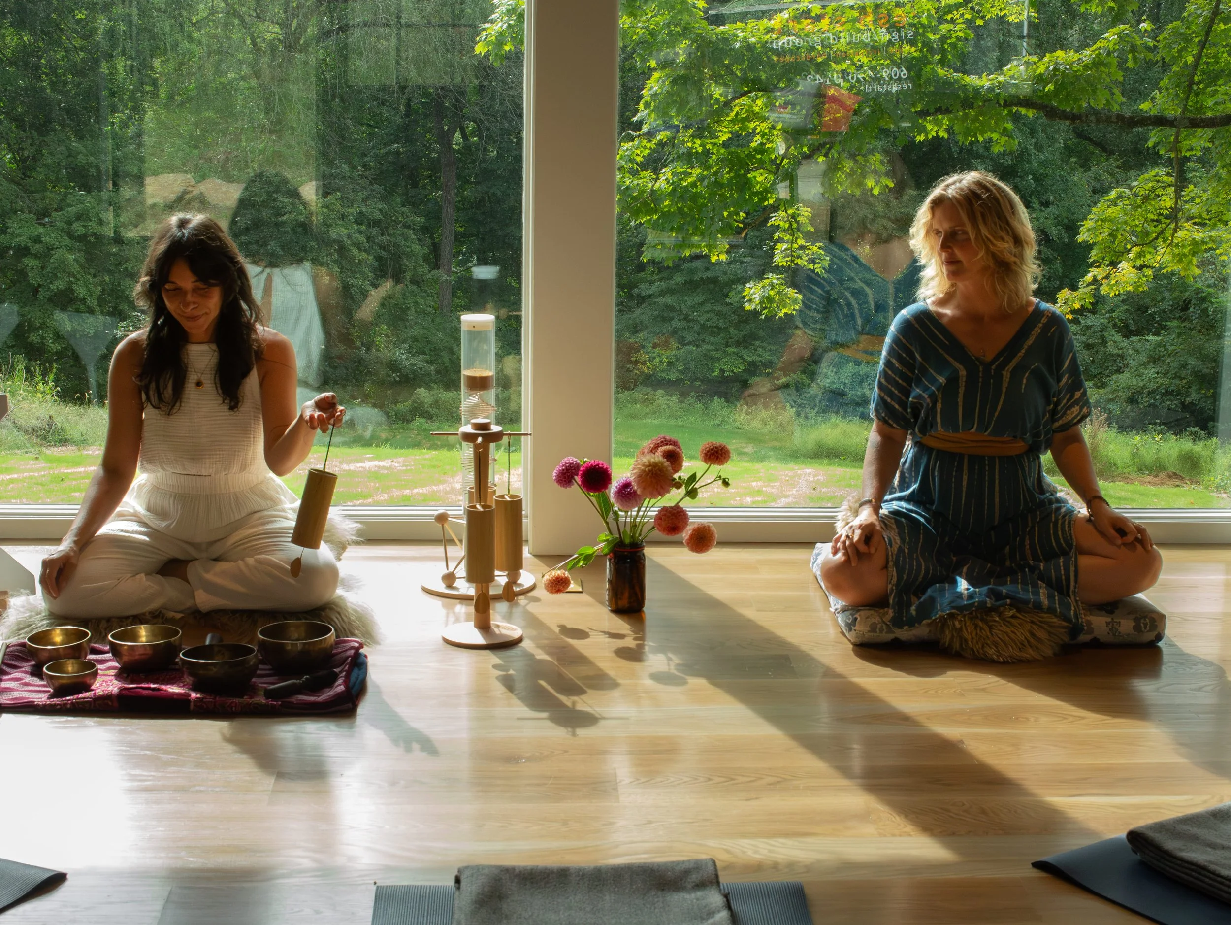 Two women facilitating yoga nidra and a sound bath
