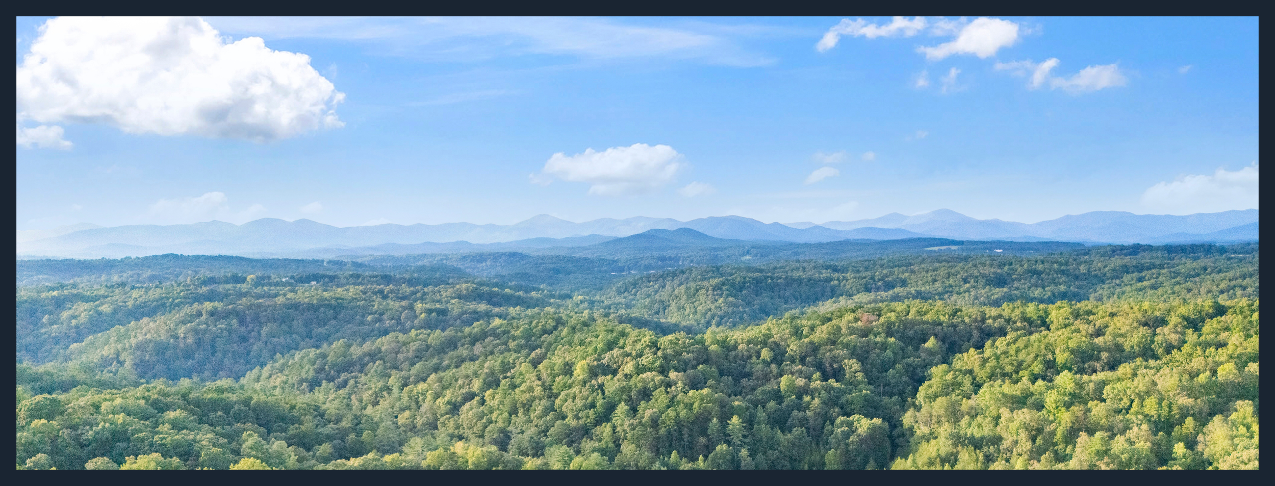 View from Dahlonega, Georgia of the North Georgia mountains under a partly cloudy sky.