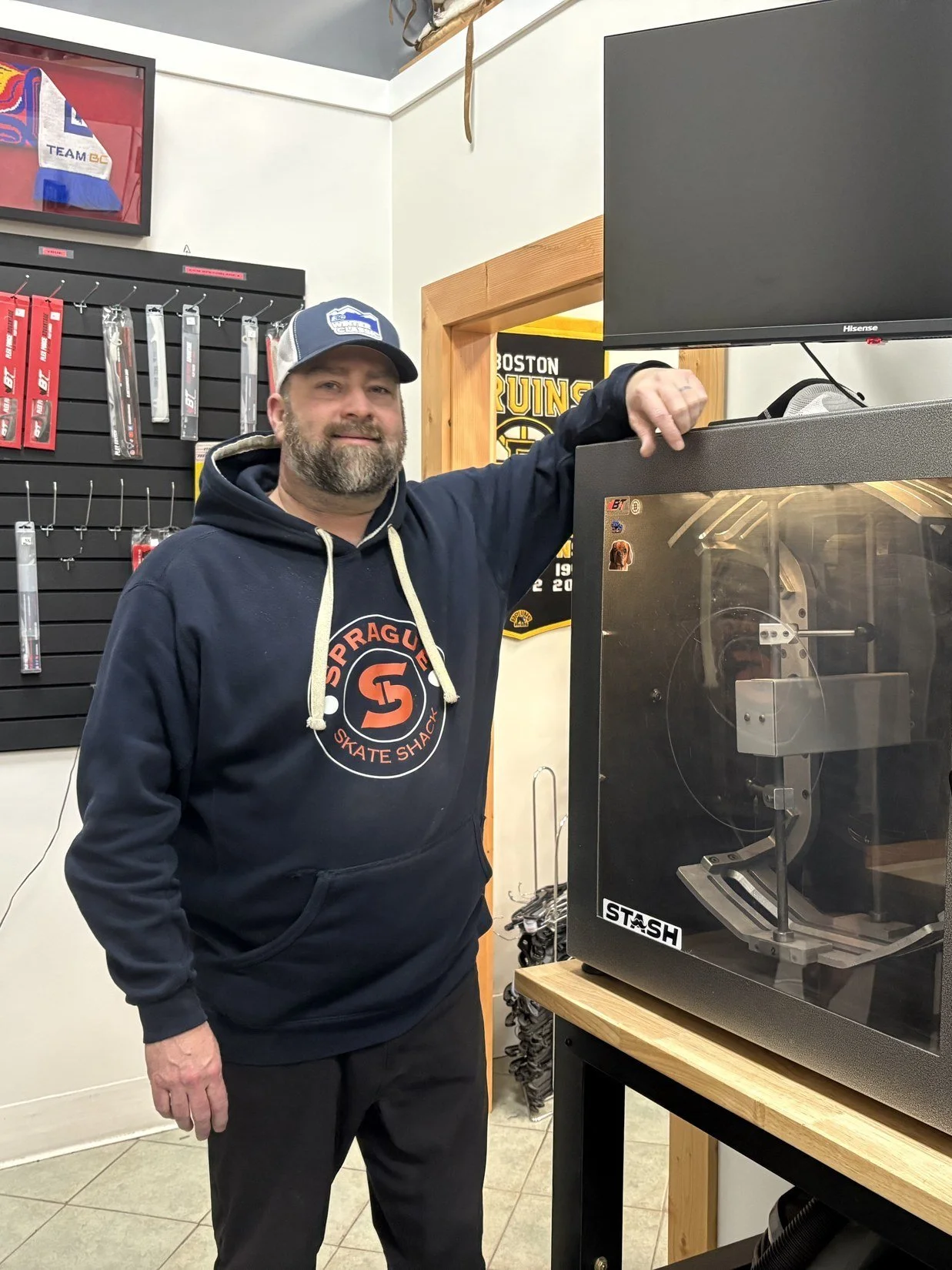 Jessie Sprague beside the Blackstone Fireball skate sharpener at Sprague & Co. in Prince George