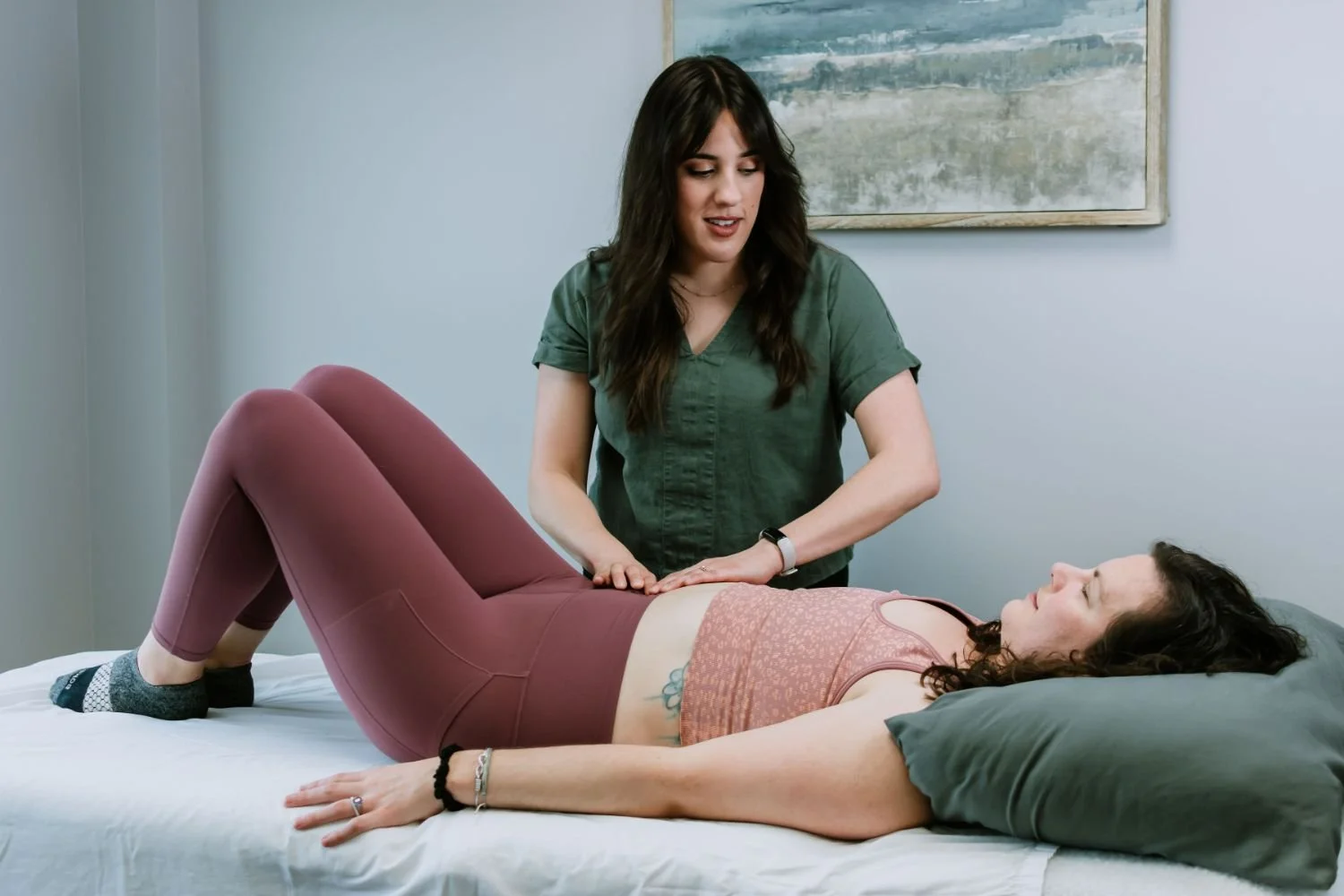 Pelvic floor physical therapist providing hands-on treatment to a patient lying on a treatment table at Kemper Pelvic Physio.