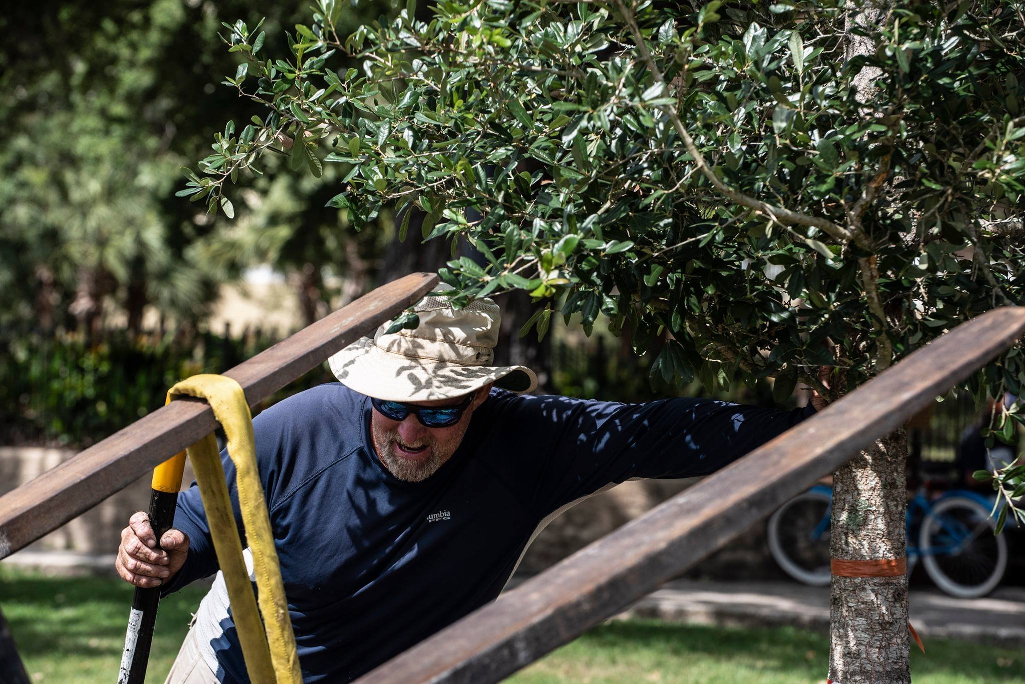 Contracted worker installing a 10-inch caliper live oak tree at Oaks by the Bay Park in Panama City, Florida, as part of a grant-funded Hurricane Michael recovery project.