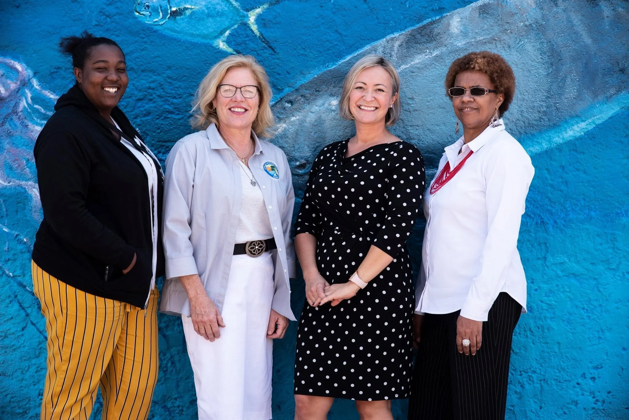 Parks, Culture and Recreation staff members including Keystone Civics founder Dr. Kesia Blenn and collaborator Chris Moser, gathered in front of  Panama City, Florida mural.