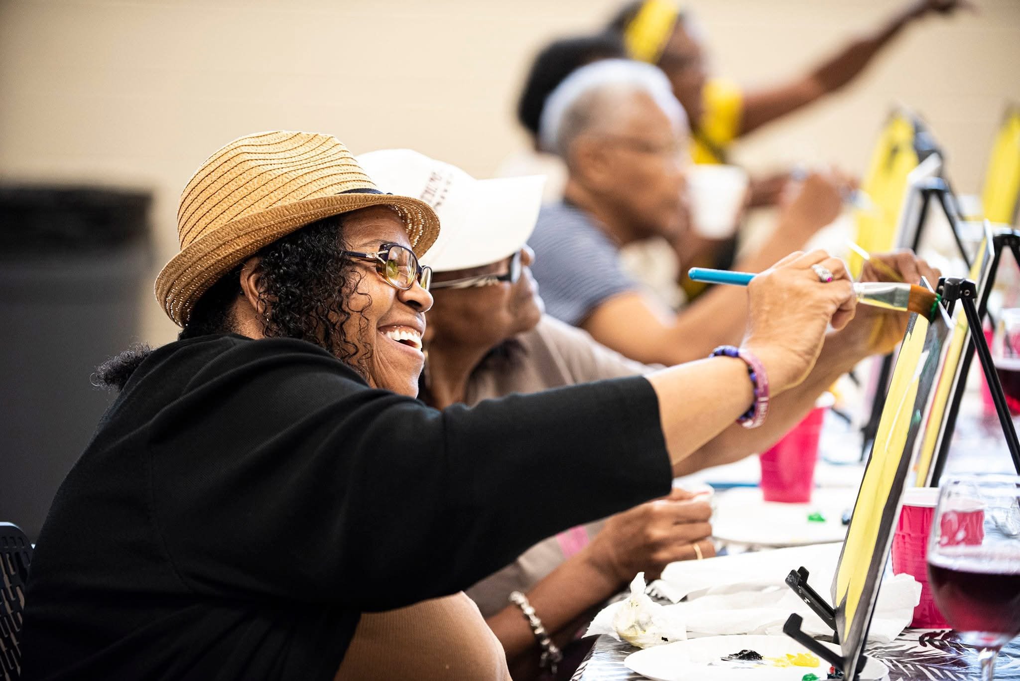 Senior adults participating in painting class developed through a partnership between Parks, Culture and Recreation, a nonprofit organization, and a local artist.