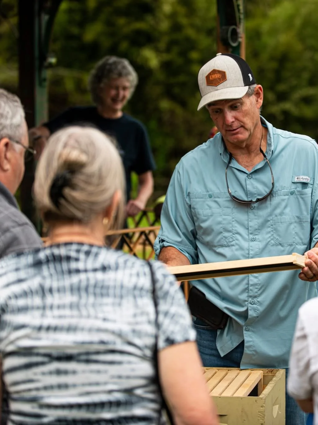Community members participating in a pollinator and beekeeping program at a community food forest in Millville, Florida.