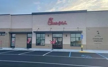 Chick-fil-A restaurant exterior with parking lot in front.