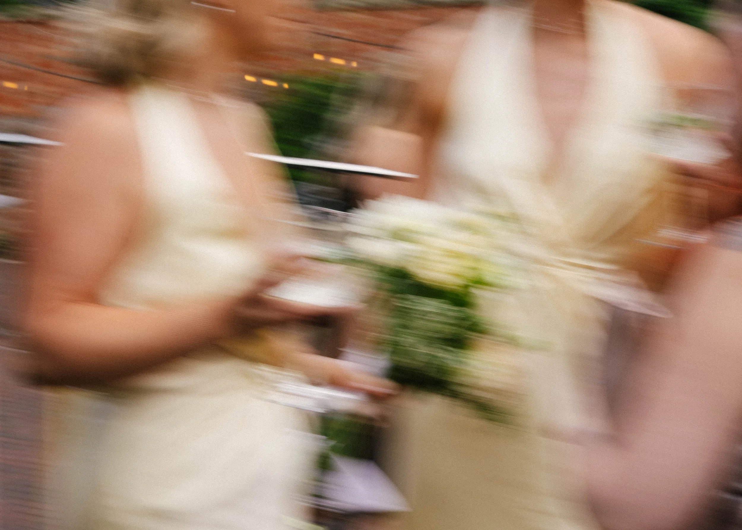 The image is blurry and appears to show a close-up of some food or plant items, possibly with hands holding or interacting with them.