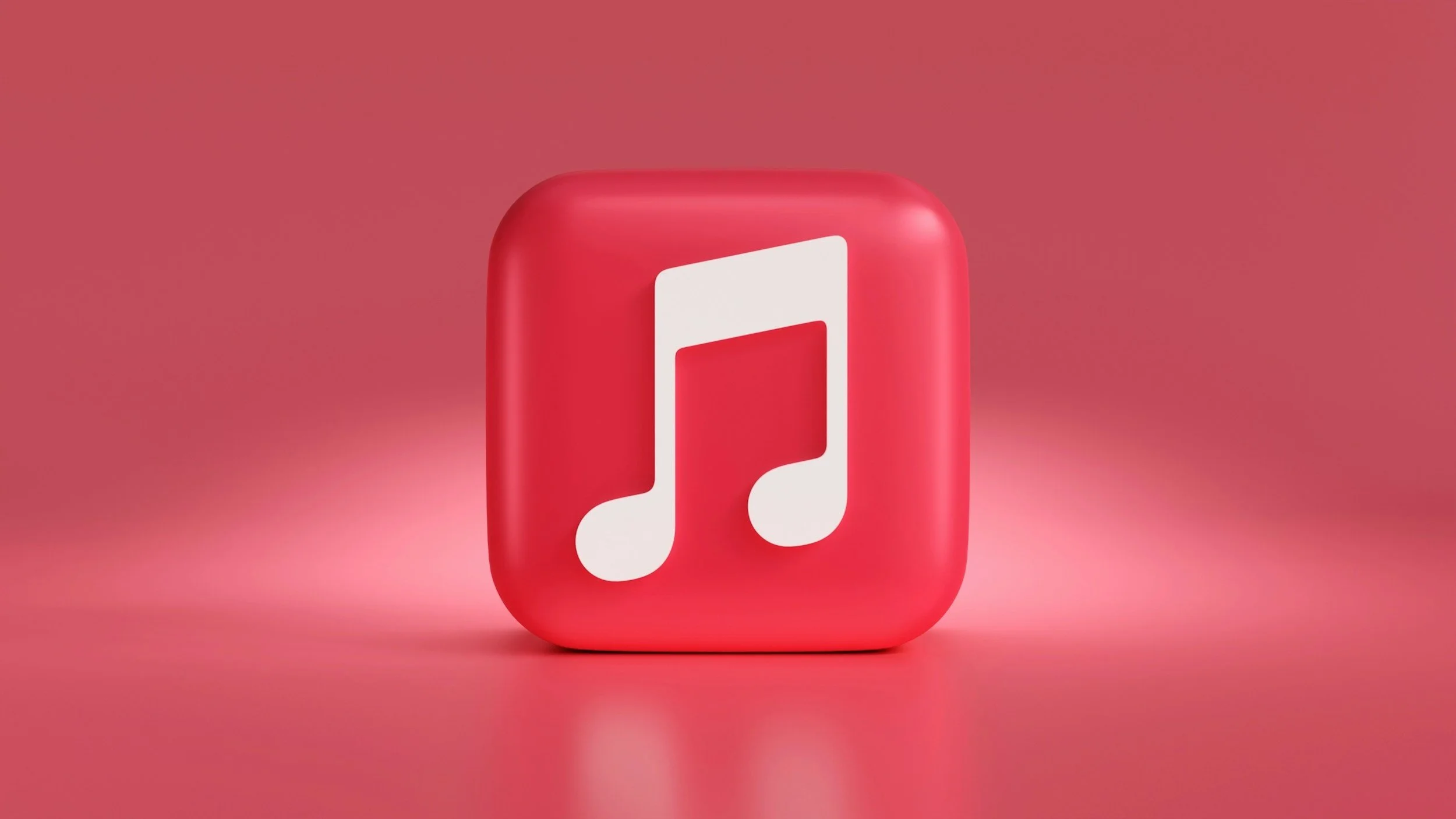 A pink 3D Apple Music  icon of a music note on a solid pink background.