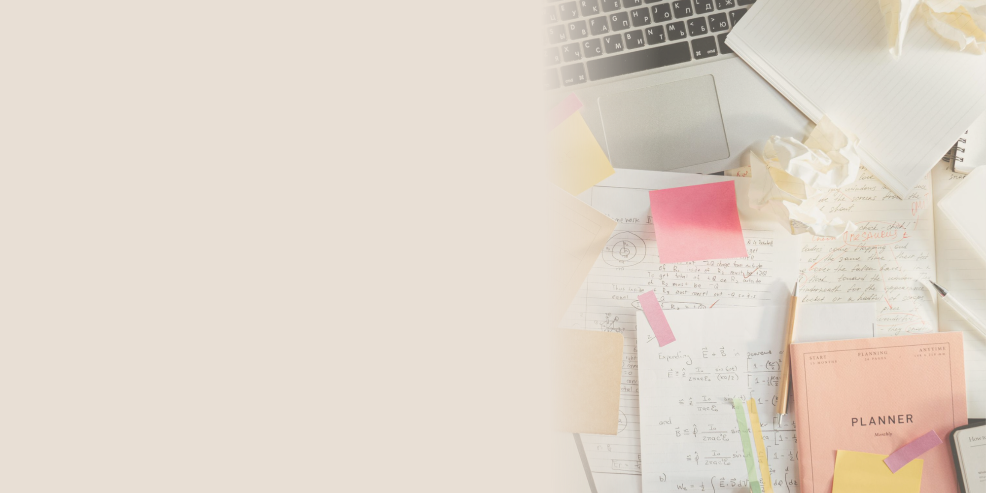 Desk covered with notes, paperwork and a laptop, representing the complexity of commissioning, funding and running a purpose-led organisation.
