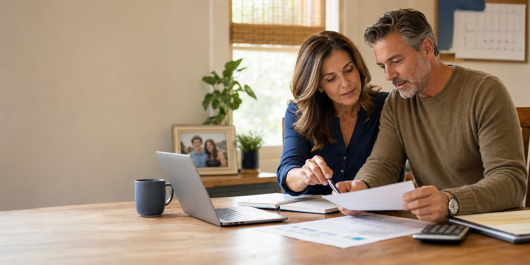 Couple in their 40s reviewing their financial plan together at home