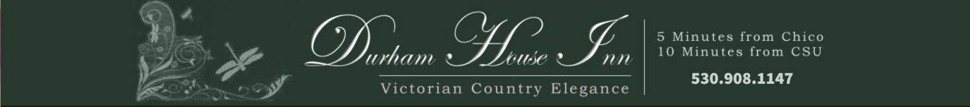 Sign for Durham House Inn with elegant font and decorative dragonfly and floral graphics, indicating its location and contact information.