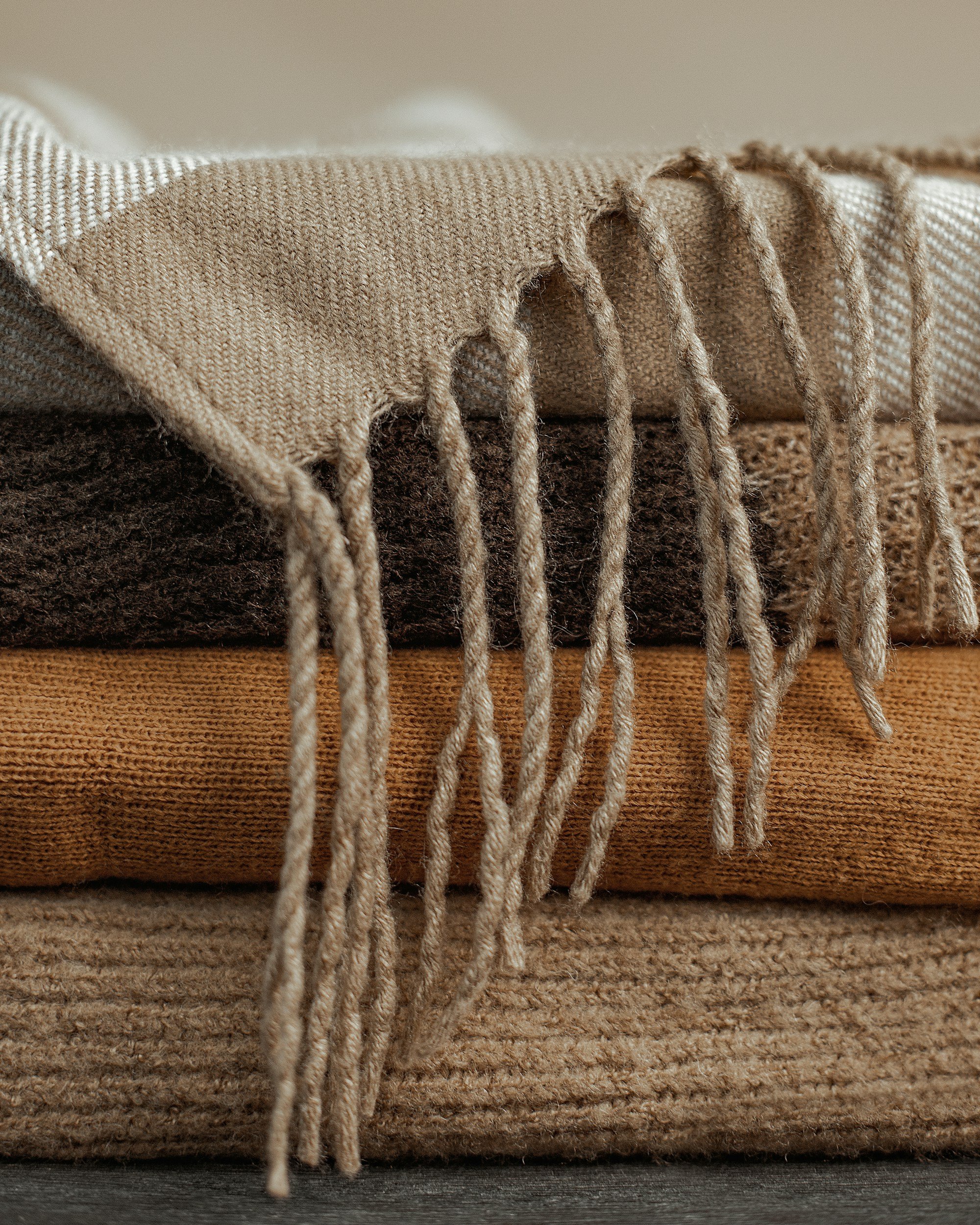 Stacked pile of textured rebozo cloths for a Closing of the Bones postpartum ritual in San Antonio