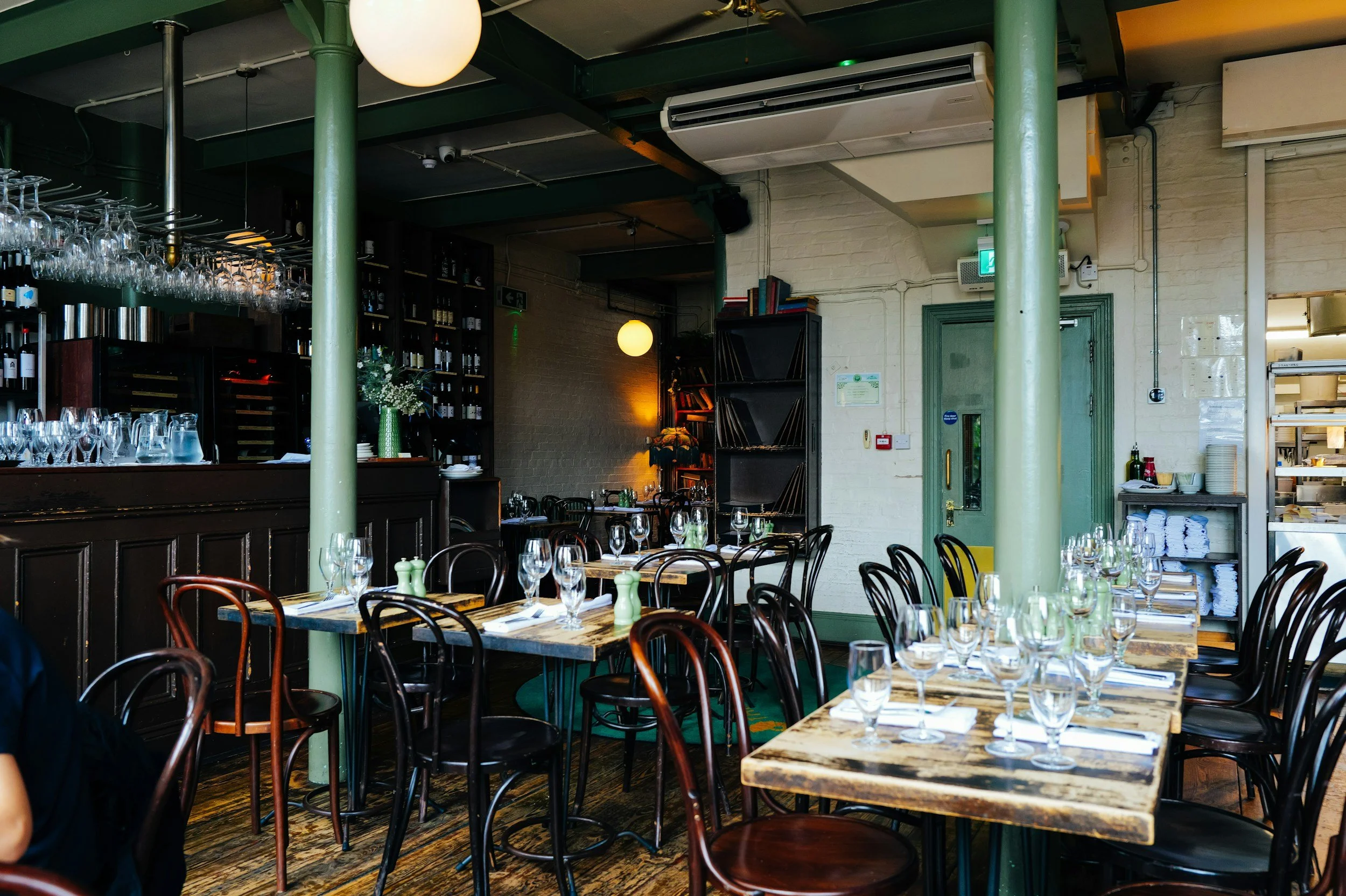 Independent restaurant dining room with bar and table seating.