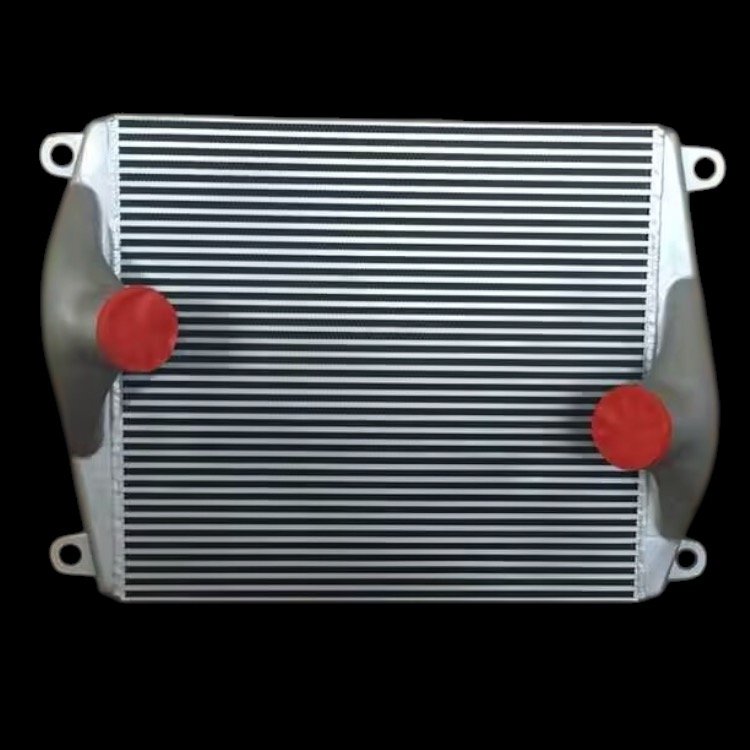 An aluminum car radiator with two red caps, displayed against a black background.