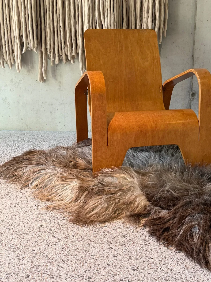 Moonstone by Wol Society, a shaggy smoky brown and grey sheepskin rug with frosted tips
