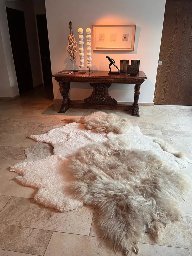 Mieke 196 by Wol Society, an ivory sheep skin rug dotted with long, fluffy taupe pelts