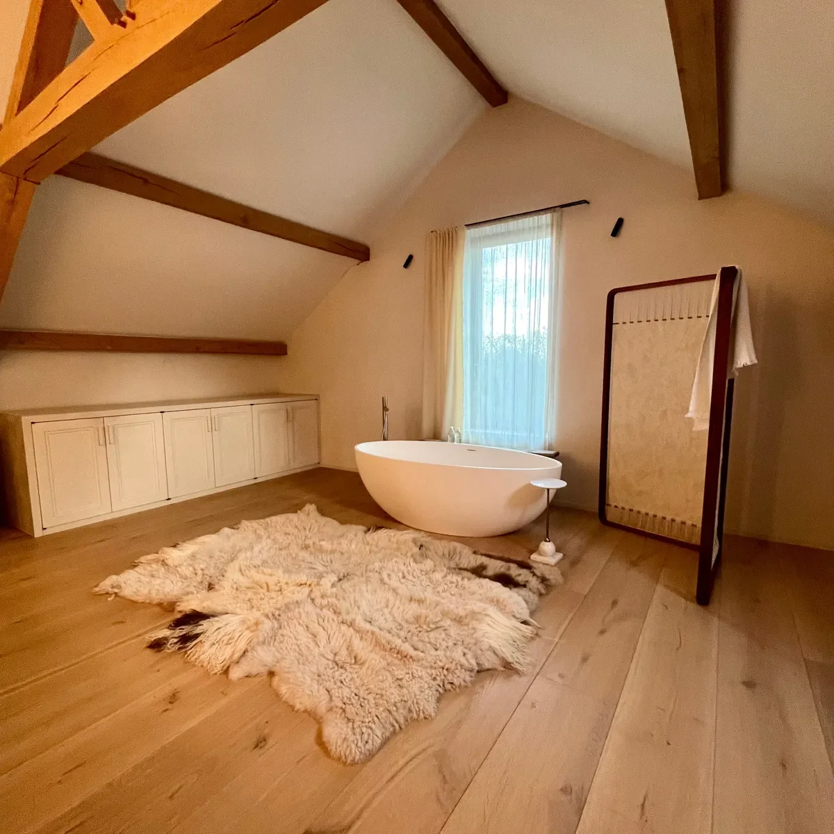 Ivy by Wol Society, a shaggy oatmeal and honey sheep skin rug with darker tips at the edges