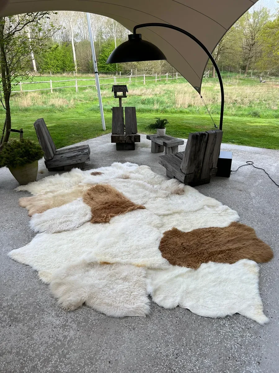 Coqui by Wol Society, a huge white sheepskin rug with two caramel pelts