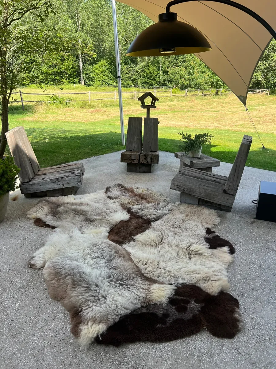 Muffin by Wol Society, a curly oatmeal and grey-taupe sheep skin rug with chocolate brown pelts