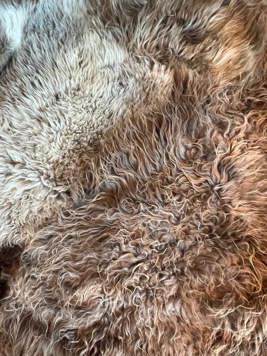 Joep by Wol Society, a brown and grey patchwork sheepskin rug with long, layered fleece