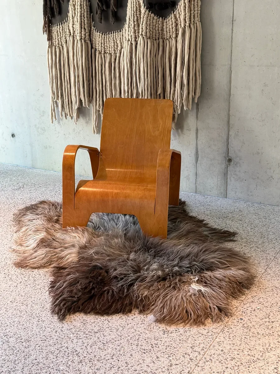 Moonstone by Wol Society, a shaggy smoky brown and grey sheepskin rug with frosted tips