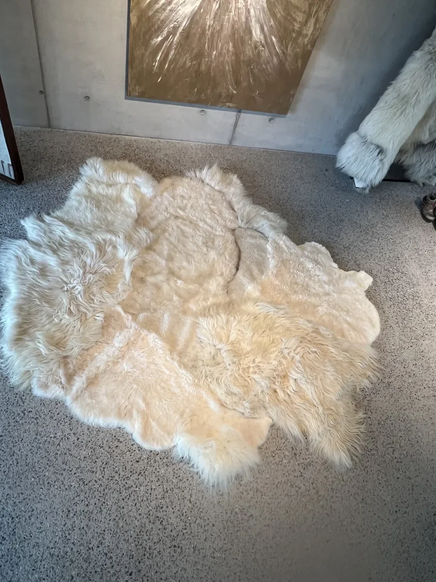 PomPom by Wol Society, a buttery cream sheep skin rug with long, fluffy edges