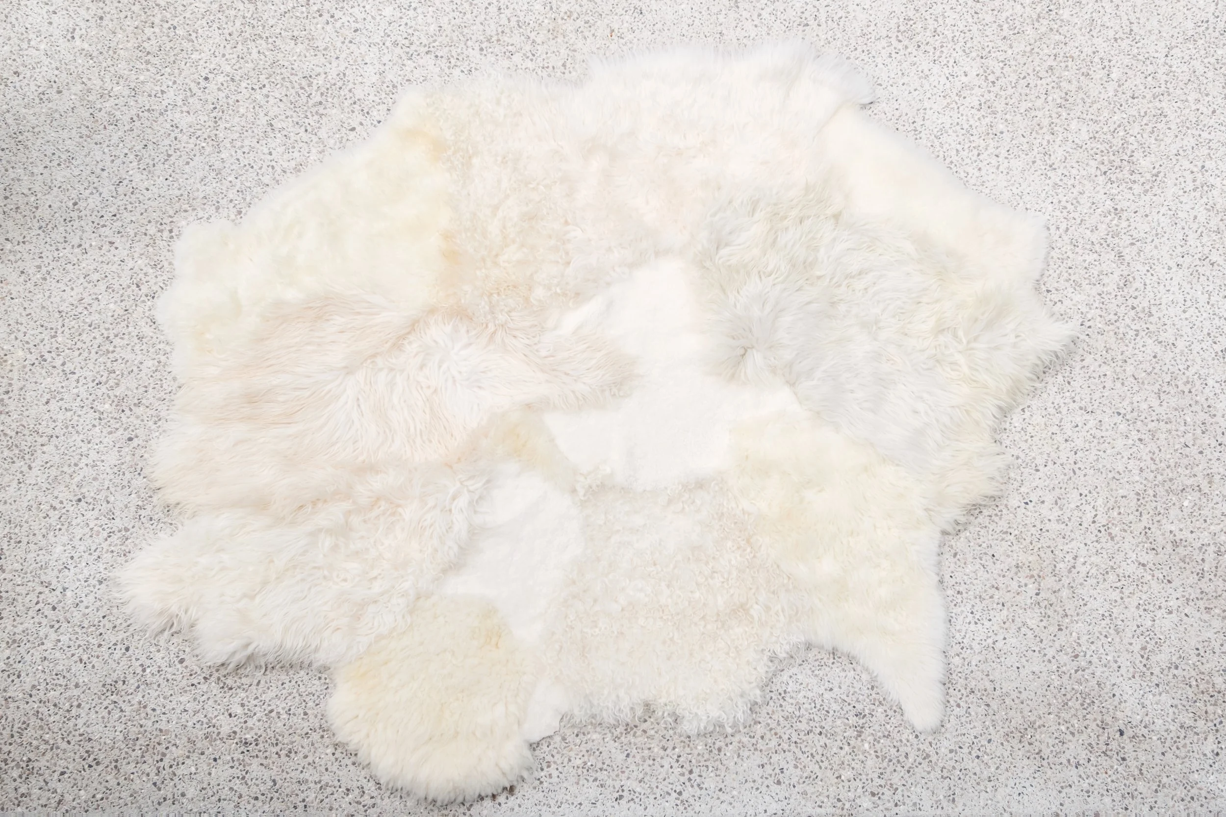 Kai - Wavy Ivory Patchwork Sheepskin Rug (75 x 102 in.)