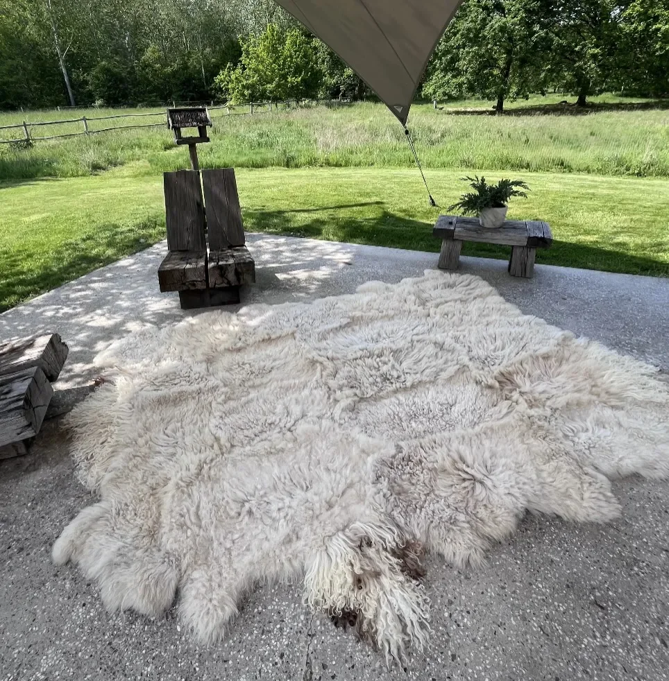 Blumi by Wol Society, a wavy soft white sheepskin rug with wavy curls