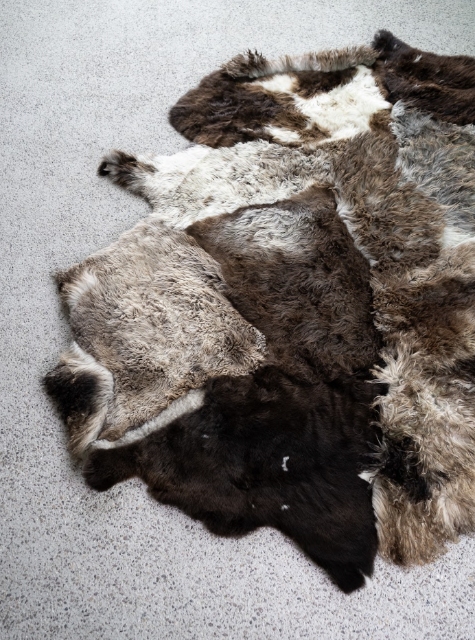 Breezy by Wol Society, a patchwork sheepskin rug in chocolate, taupe and frosted grey with one brown-and-white pelt