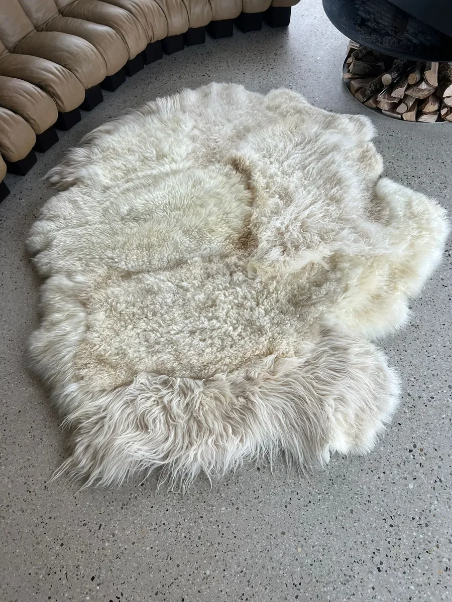Princess by Wol Society, an ivory sheep skin rug with tight curls and long, silky locks