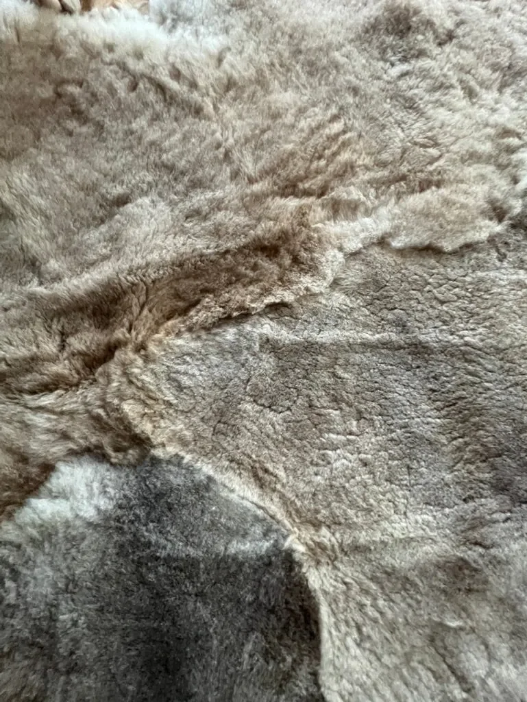 Mieke 202 by Wol Society, a taupe and silvery grey Shetland lambskin carpet.
