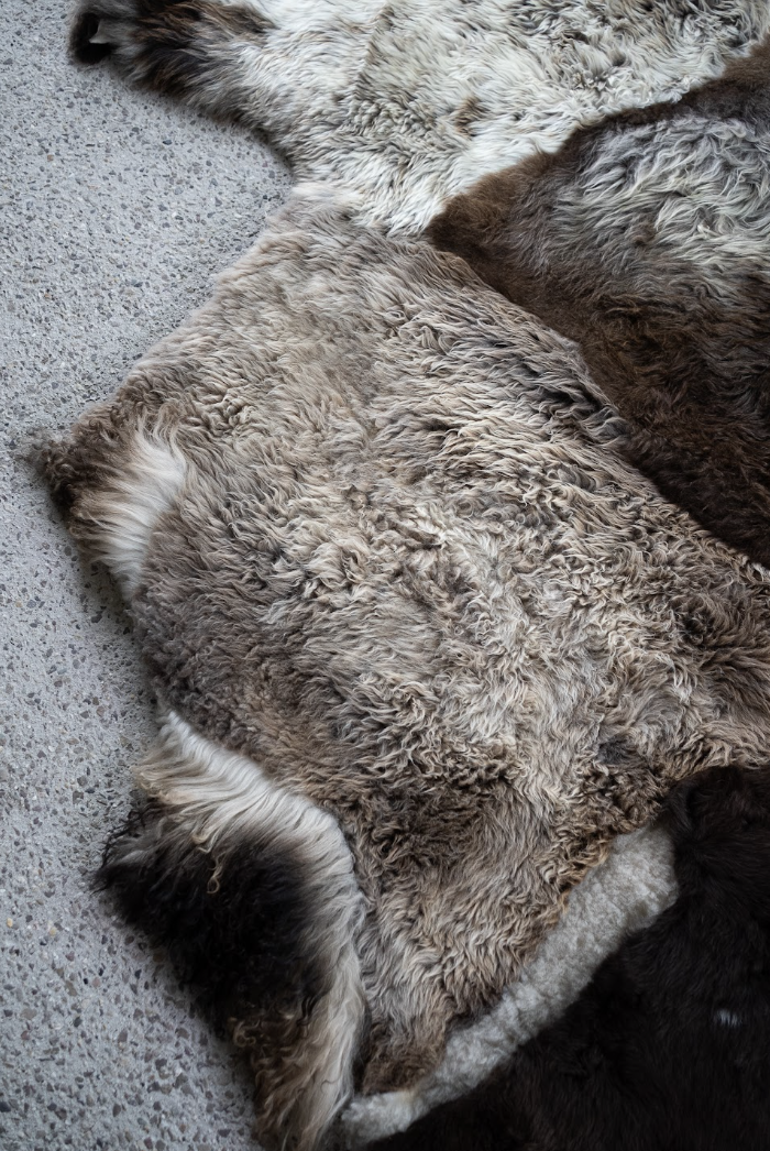 Breezy by Wol Society, a patchwork sheepskin rug in chocolate, taupe and frosted grey with one brown-and-white pelt