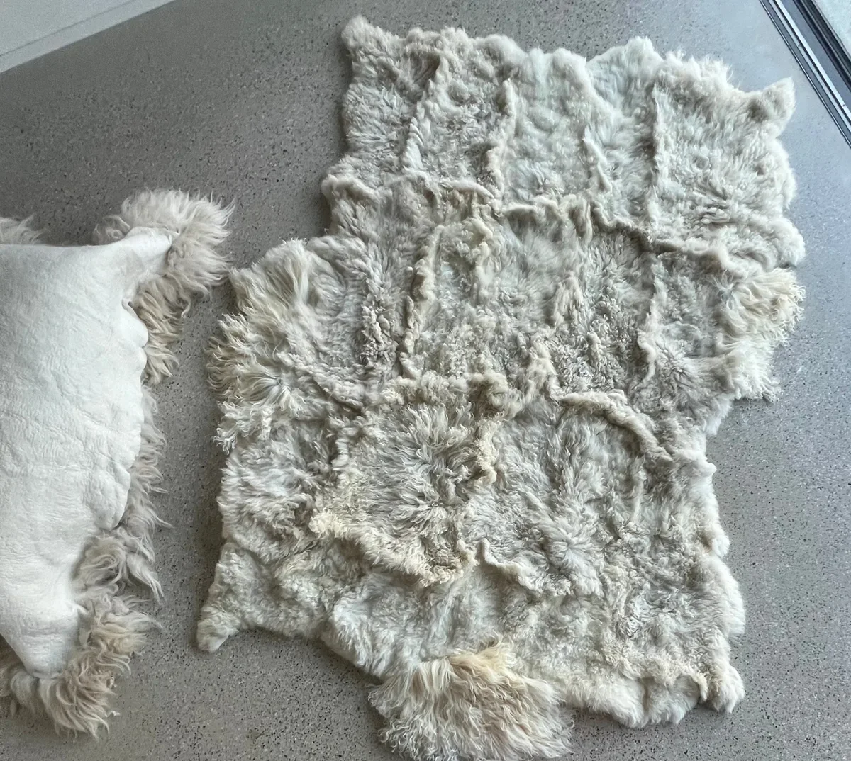 Pixie 2 by Wol Society, an ivory sheep skin rug with long, wavy fleece and soft grey undertones