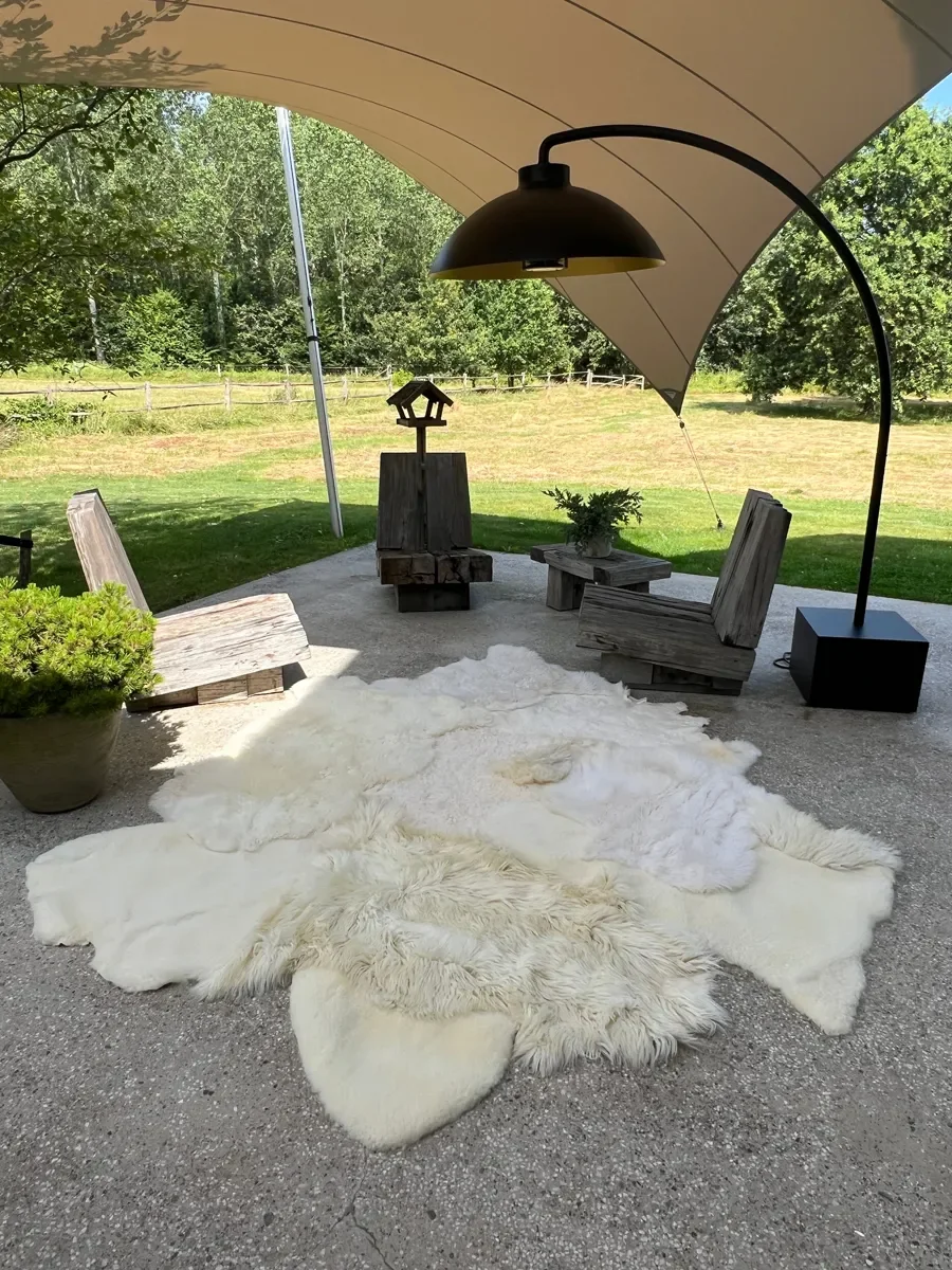 Sjoe by Wol Society, a near-square white sheepskin rug with smooth, curly and fluffy patches