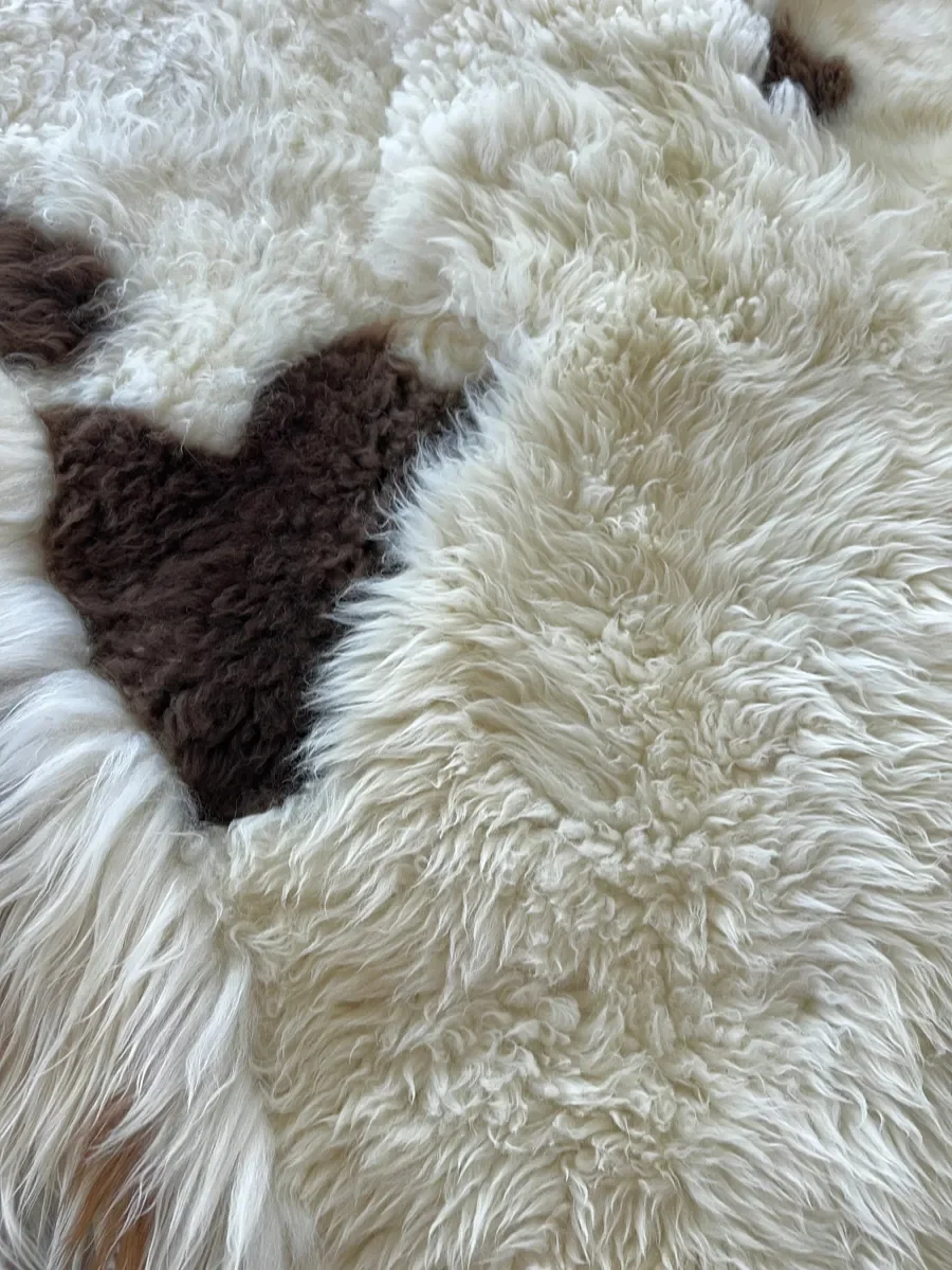 Latte Macchiato by Wol Society, a cream sheep skin rug with patches of chocolate brown
