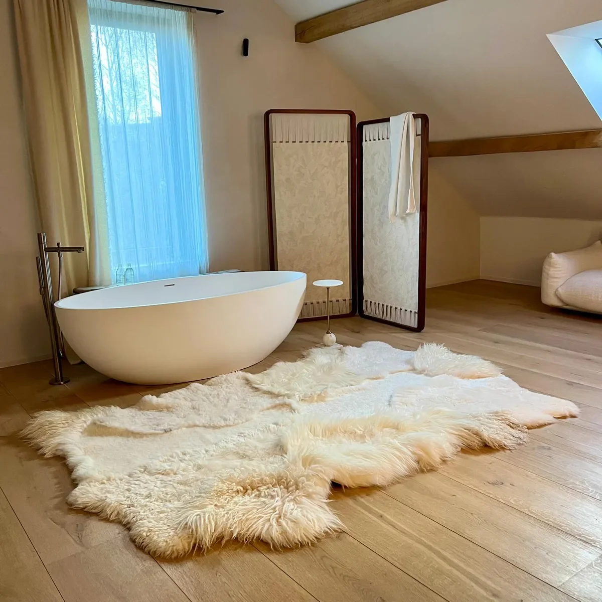 Silence by Wol Society, a buttery ivory sheep skin rug with smooth pelts and long, silky edges