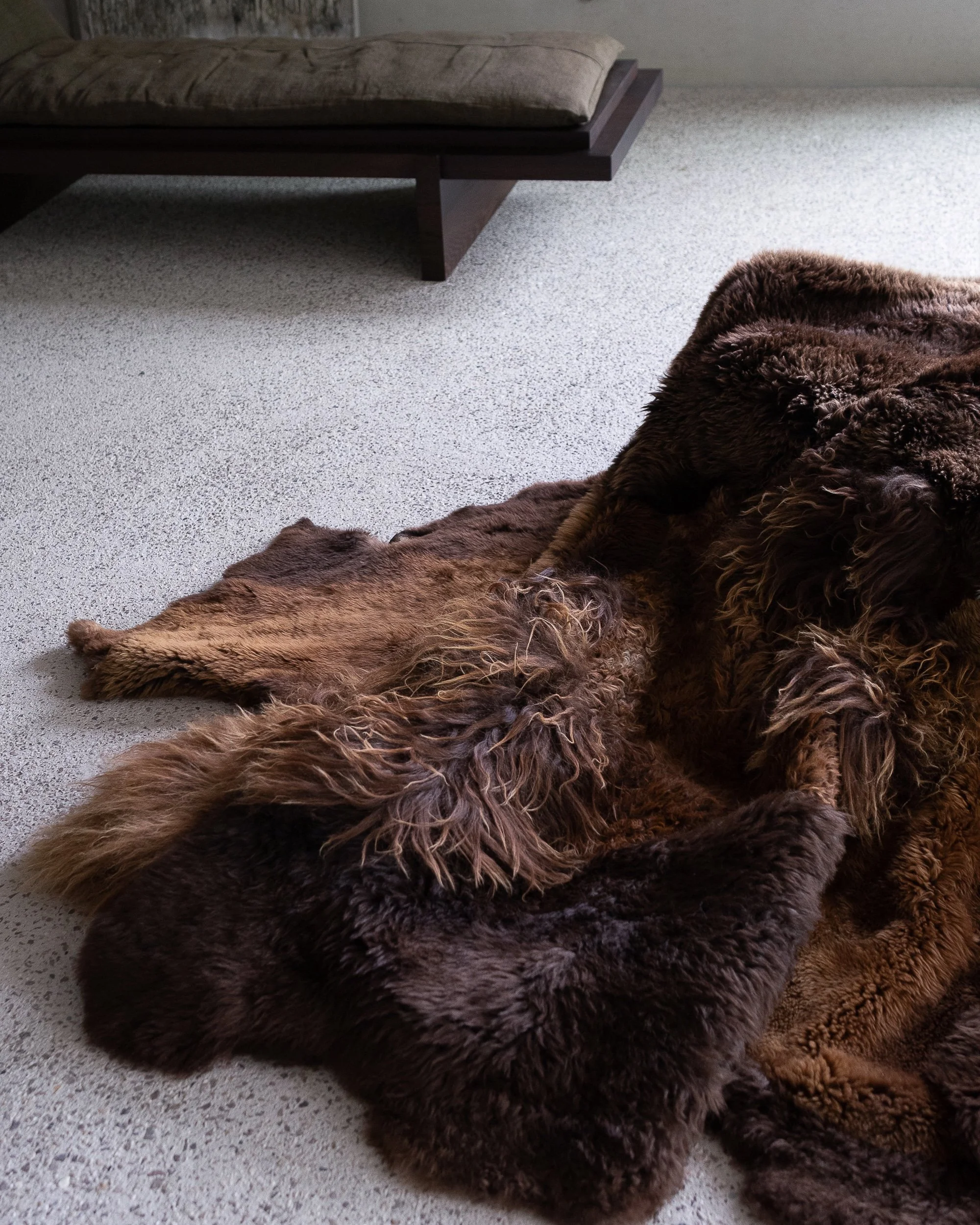 Casper by Wol Society, a shaggy deep chocolate brown sheepskin rug with honey highlights