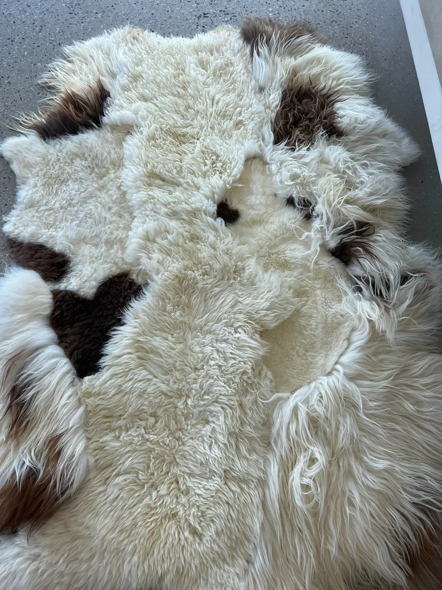 Latte Macchiato by Wol Society, a cream sheep skin rug with patches of chocolate brown
