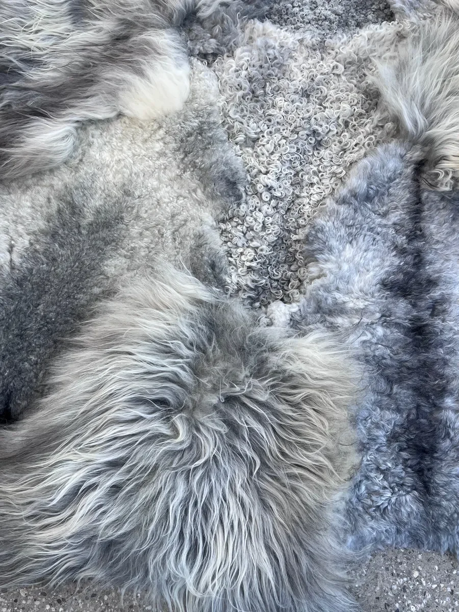 Graphite by Wol Society, a grey sheepskin rug in silver, slate and charcoal with long, silky waves