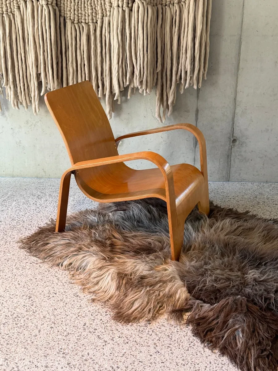 Moonstone by Wol Society, a shaggy smoky brown and grey sheepskin rug with frosted tips