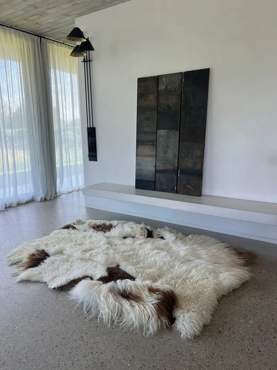 Latte Macchiato by Wol Society, a cream sheep skin rug with patches of chocolate brown