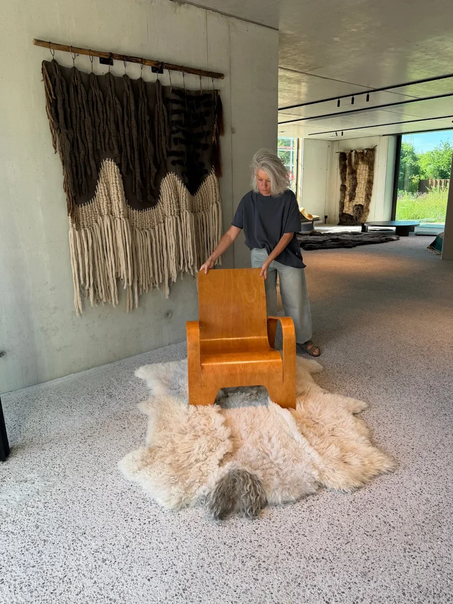 Crumble by Wol Society, a curly ivory and oatmeal sheep skin rug with a shaggy grey tuft