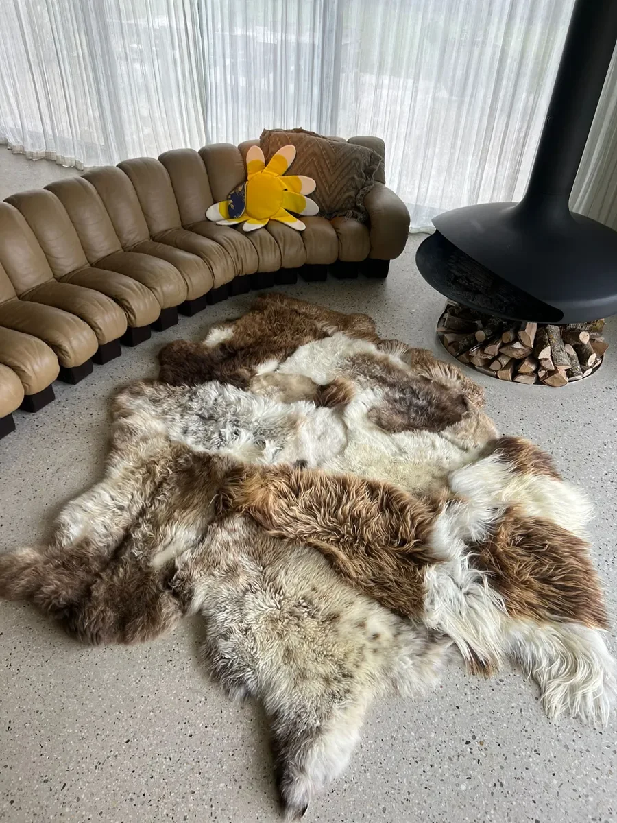 Prince by Wol Society, a large white and brown patchwork sheepskin rug with chestnut and chocolate curls