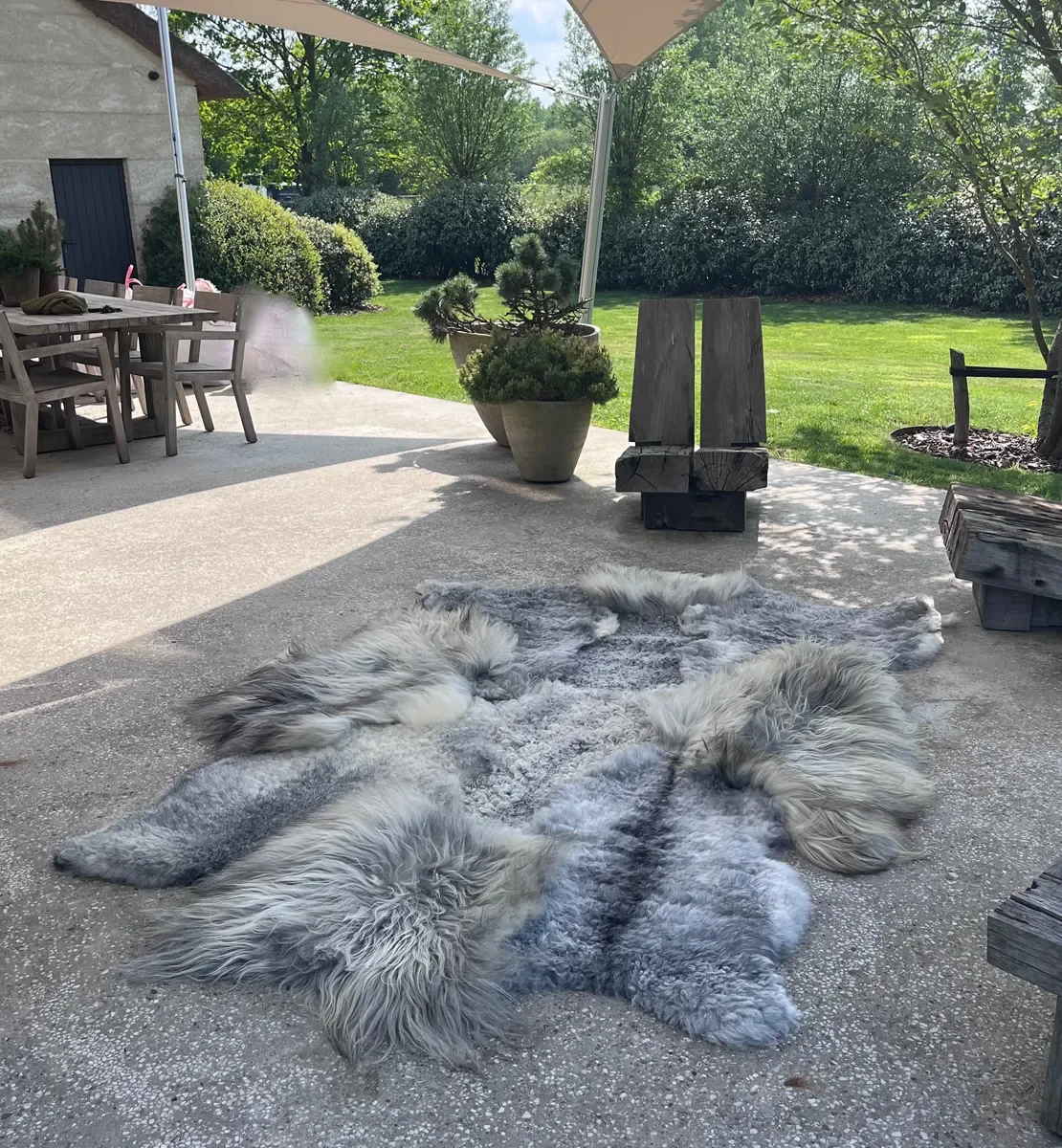 Graphite by Wol Society, a grey sheepskin rug in silver, slate and charcoal with long, silky waves