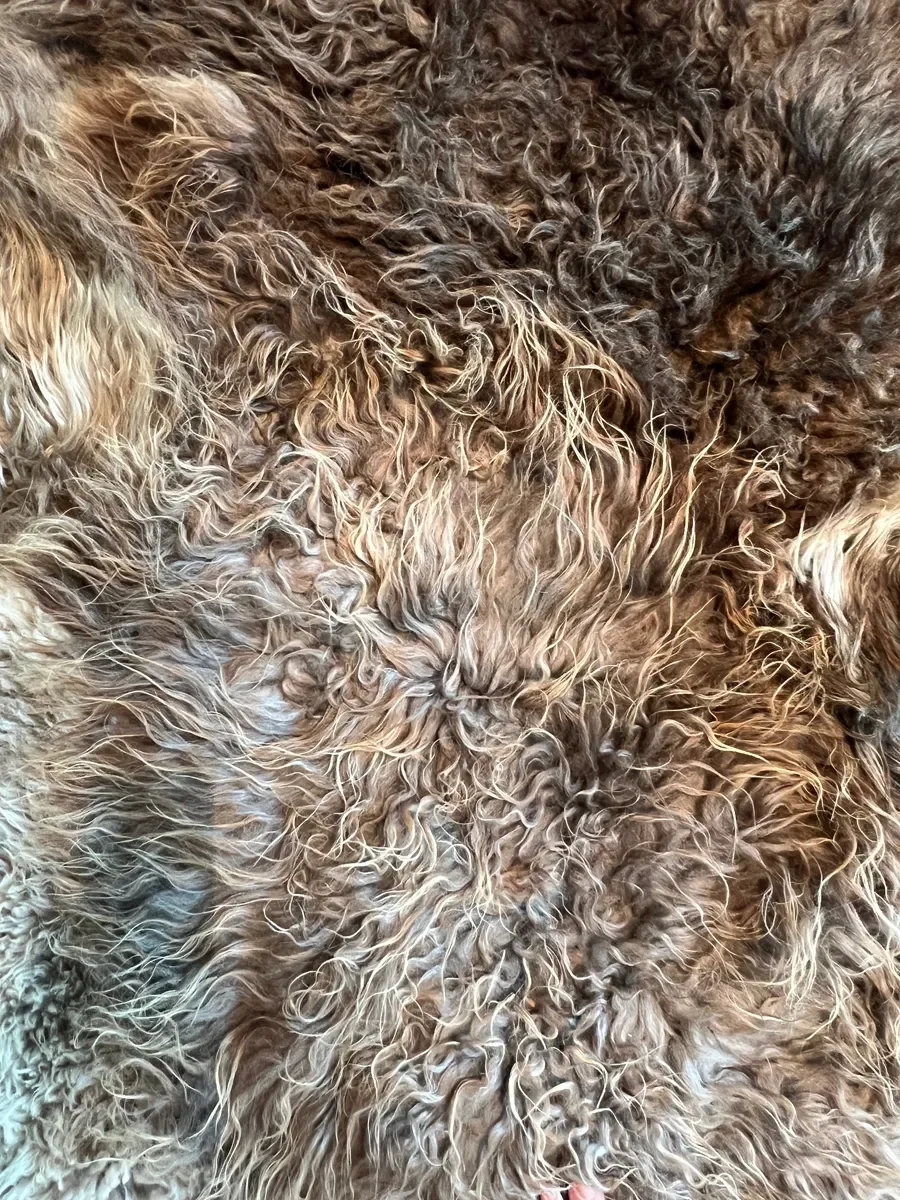 Joep by Wol Society, a brown and grey patchwork sheepskin rug with long, layered fleece