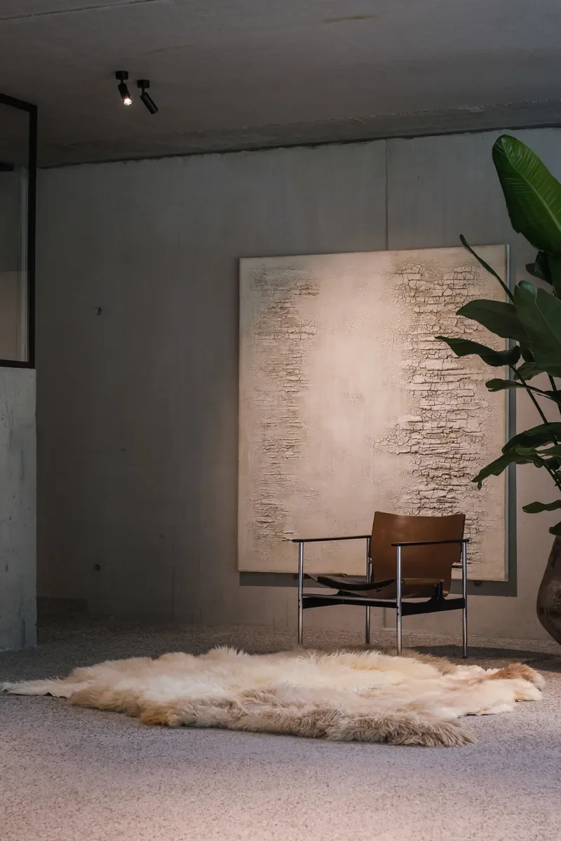 Ghost by Wol Society, a pale cream sheep skin rug with one caramel pelt along the side